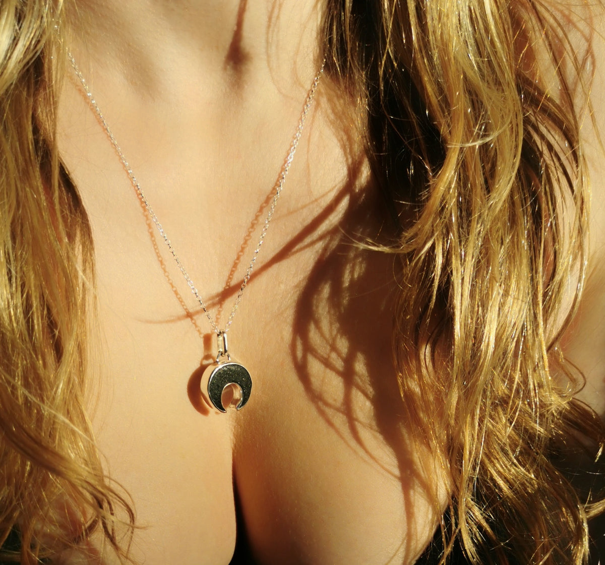Scottish black sea glass inverted crescent & sterling silver pendant.