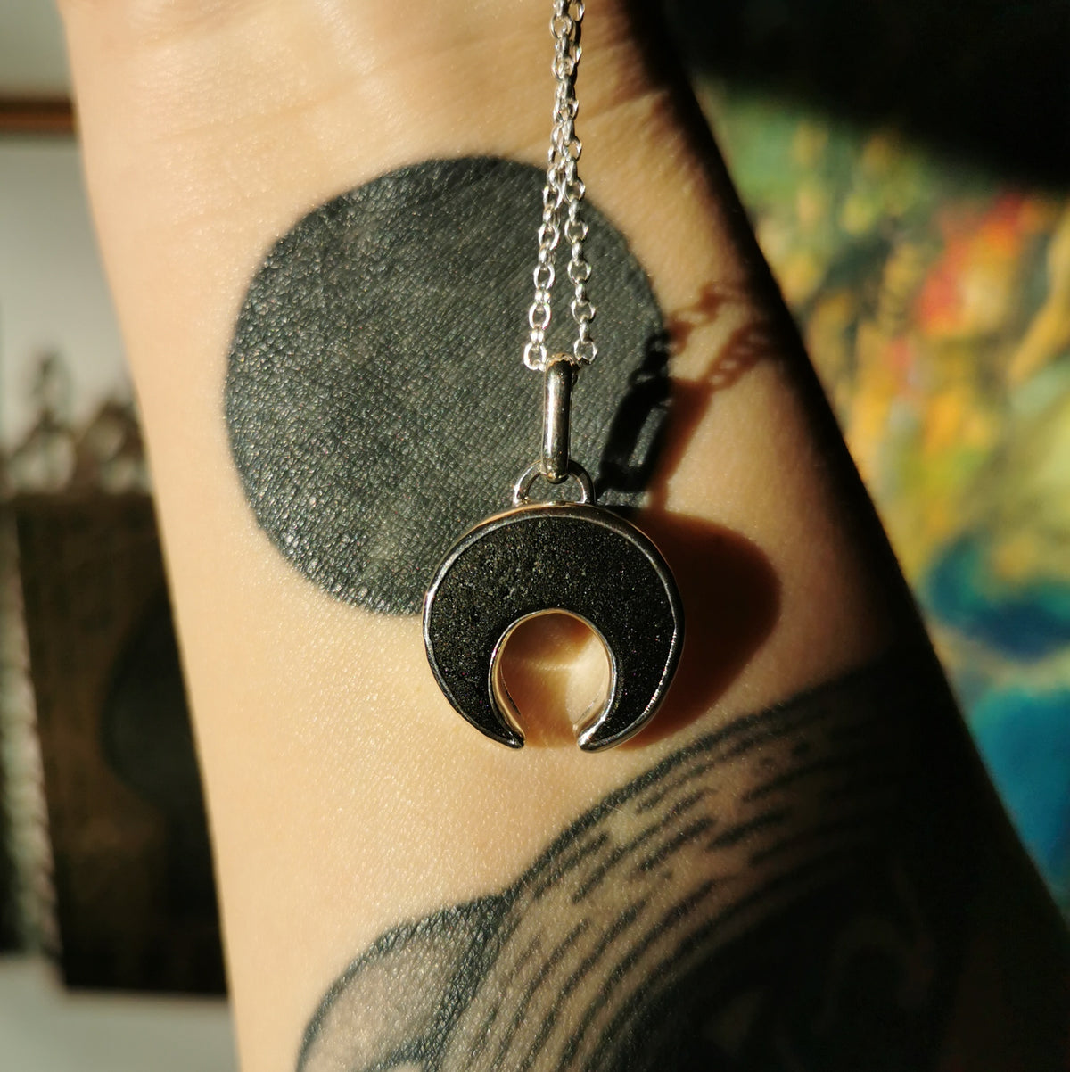 Scottish black sea glass inverted crescent & sterling silver pendant.