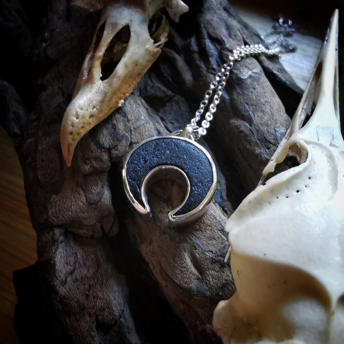 Scottish black sea glass inverted crescent & sterling silver pendant.