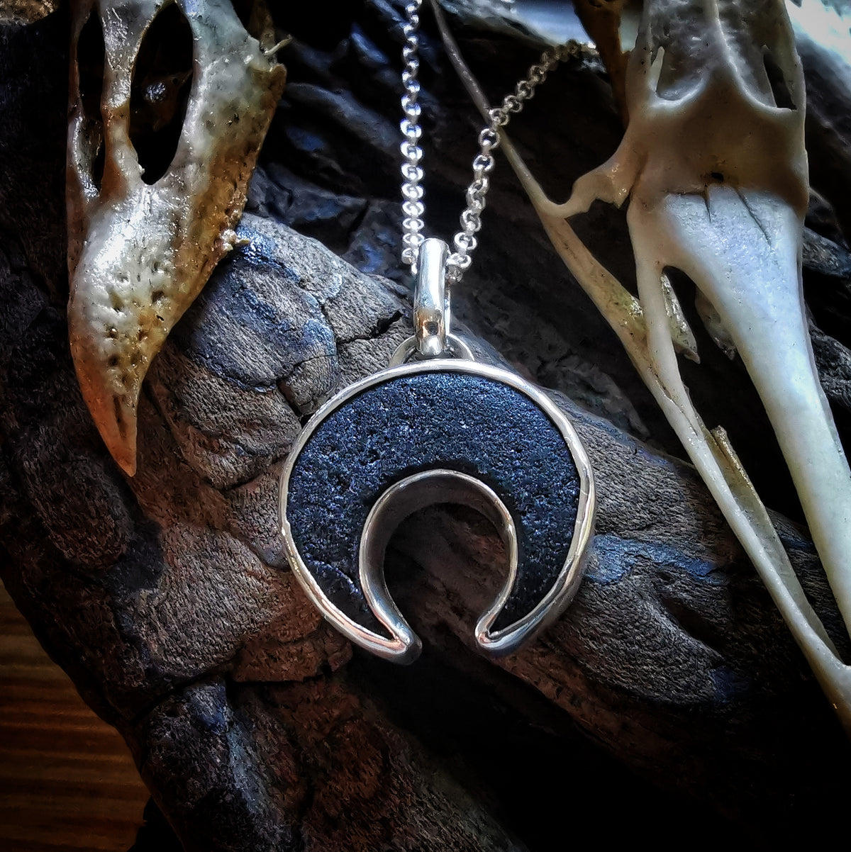 Scottish black sea glass inverted crescent & sterling silver pendant.