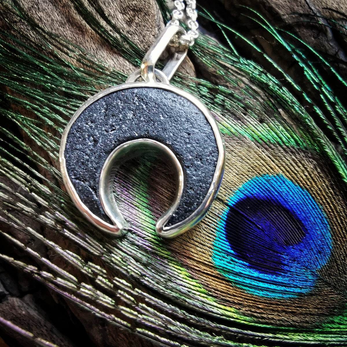 Scottish black sea glass inverted crescent & sterling silver pendant.