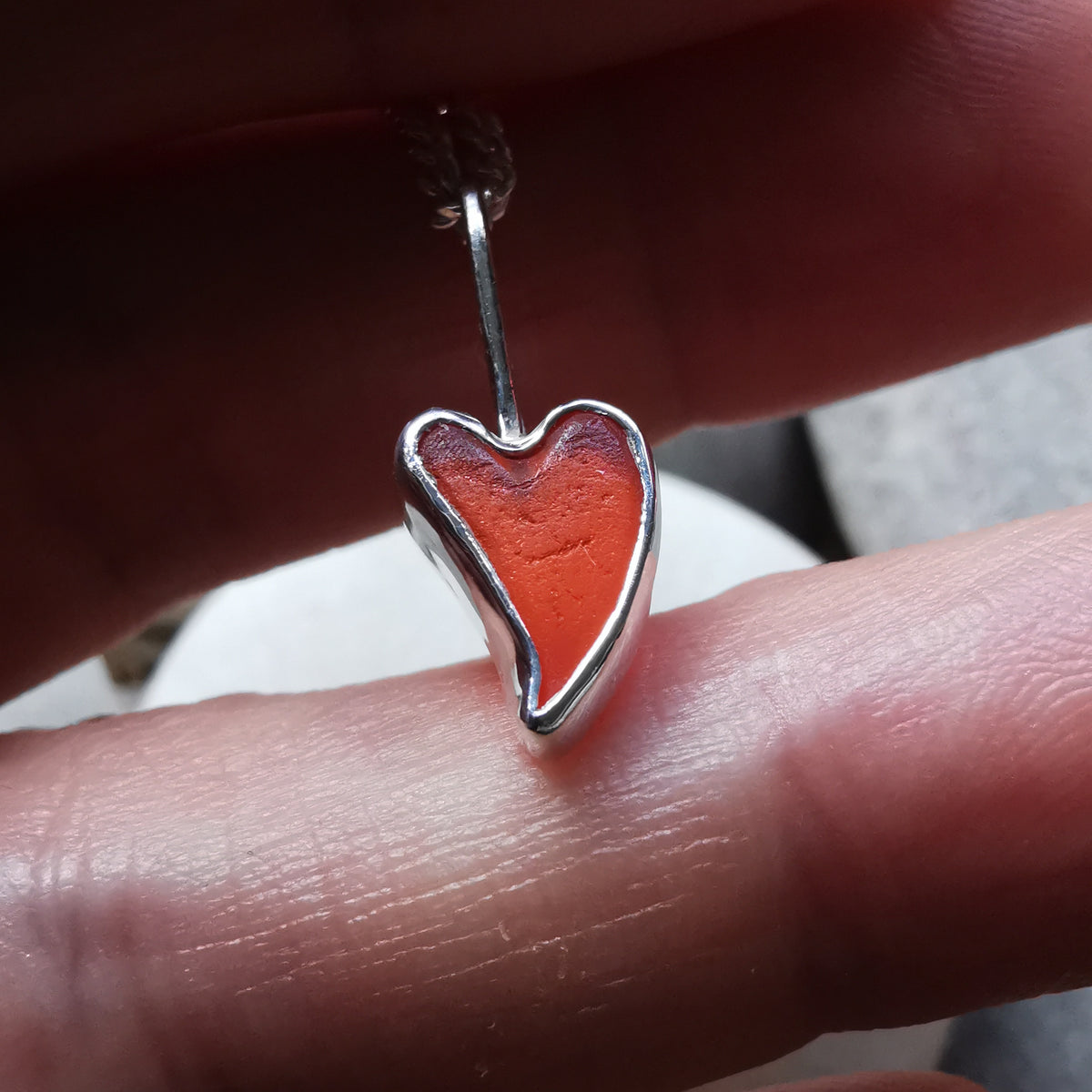 Tiny Scottish orange sea glass heart  & sterling silver pendant.