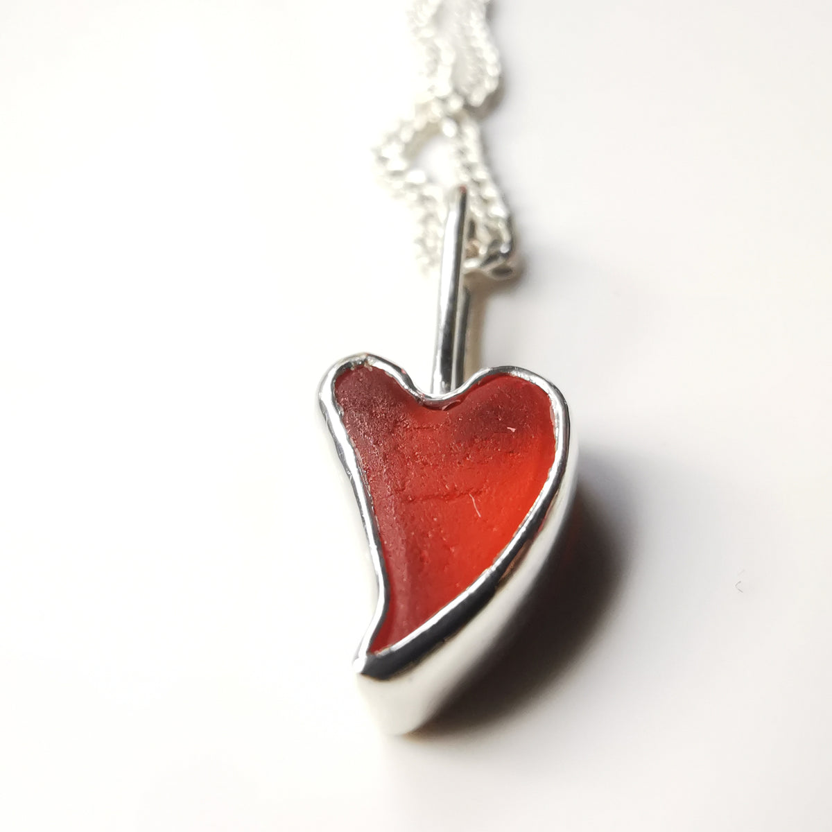 Tiny Scottish orange sea glass heart  & sterling silver pendant.