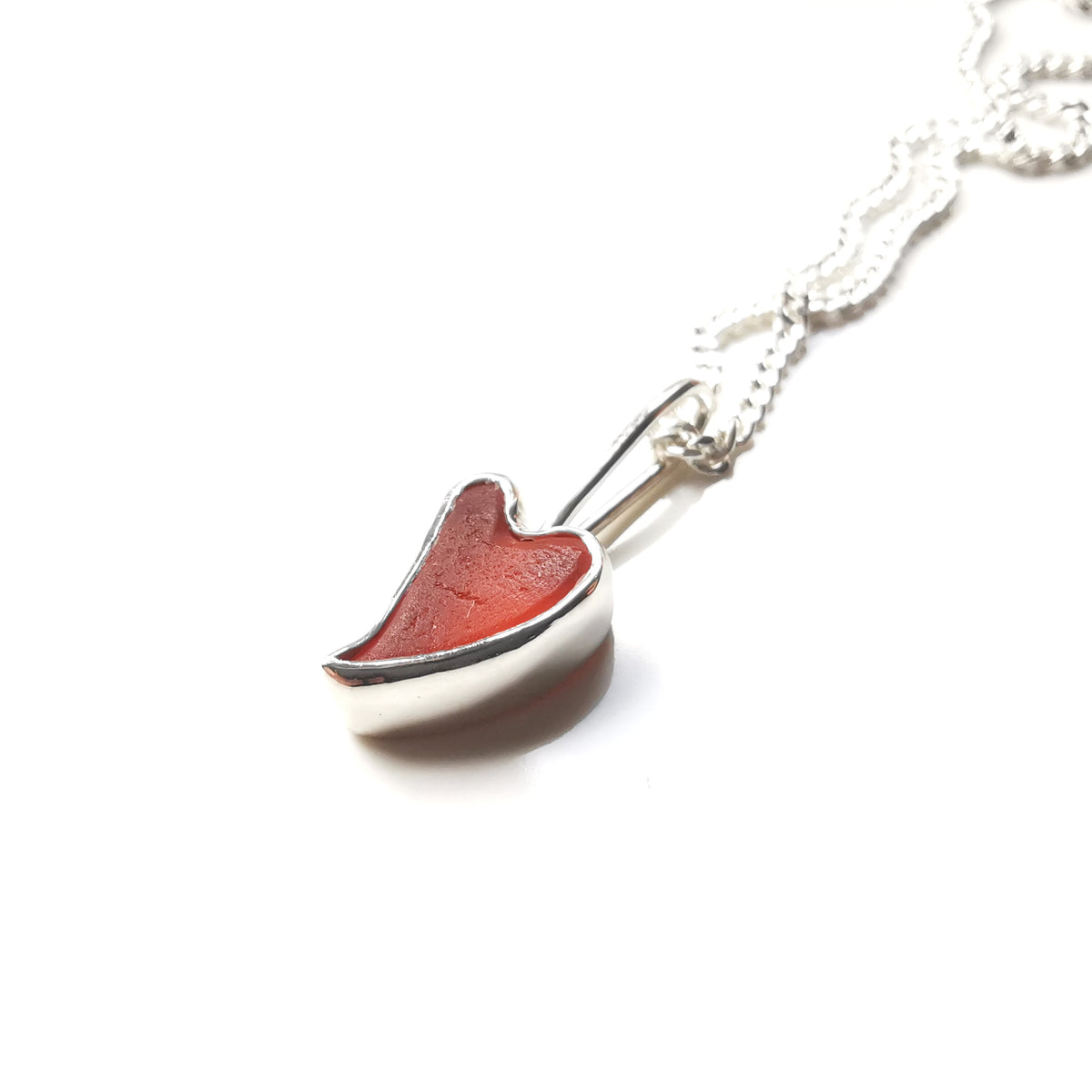 Tiny Scottish orange sea glass heart  & sterling silver pendant.