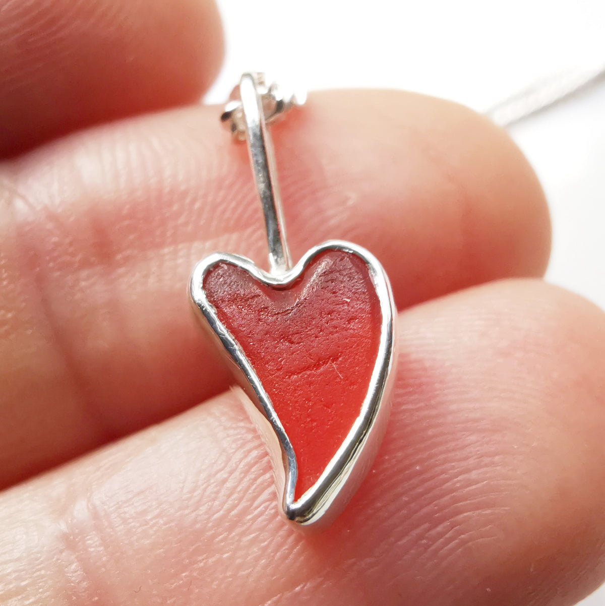 Tiny Scottish orange sea glass heart  & sterling silver pendant.