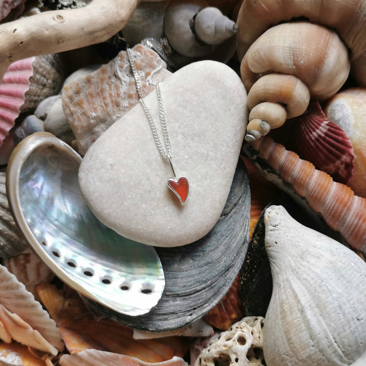 Tiny Scottish orange sea glass heart  & sterling silver pendant.