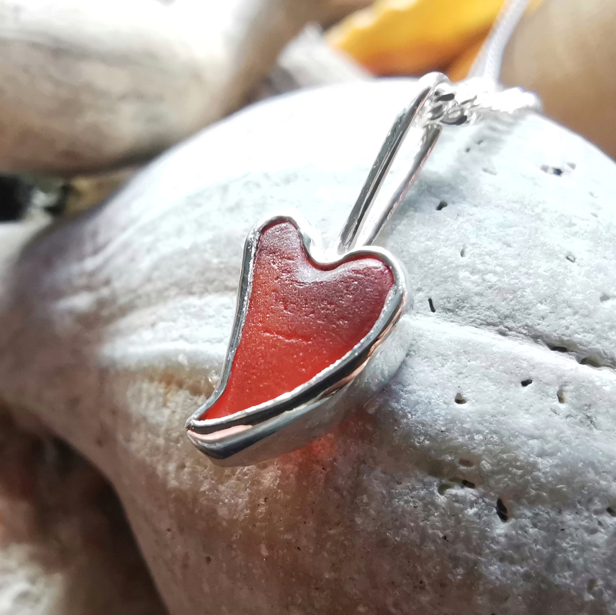 Tiny Scottish orange sea glass heart  & sterling silver pendant.