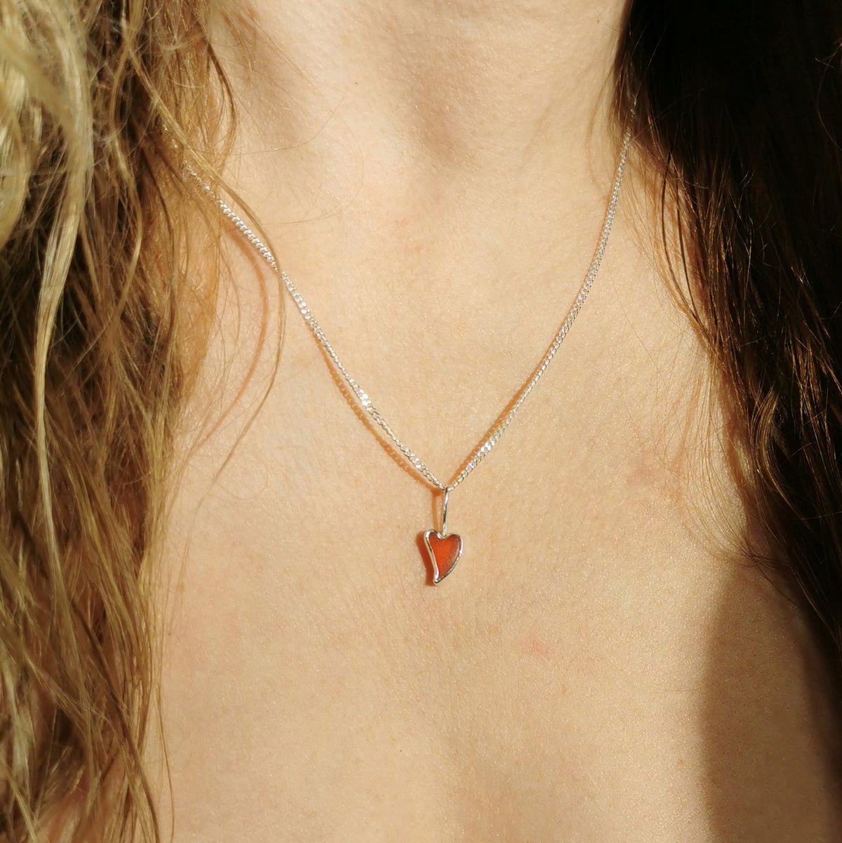 Tiny Scottish orange sea glass heart  & sterling silver pendant.