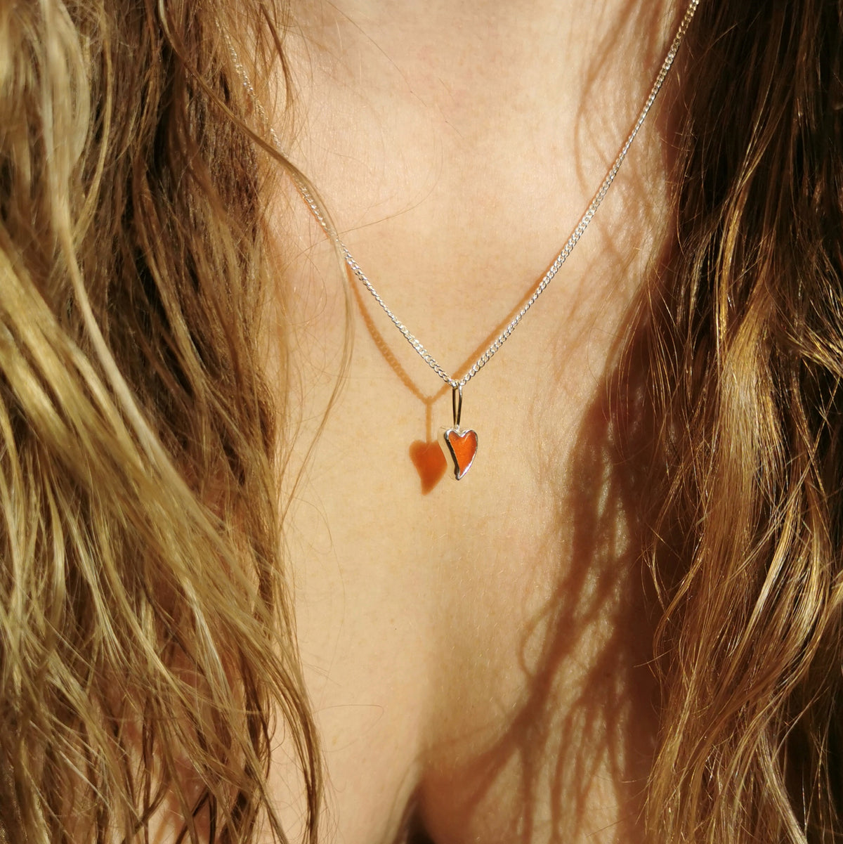 Tiny Scottish orange sea glass heart  & sterling silver pendant.