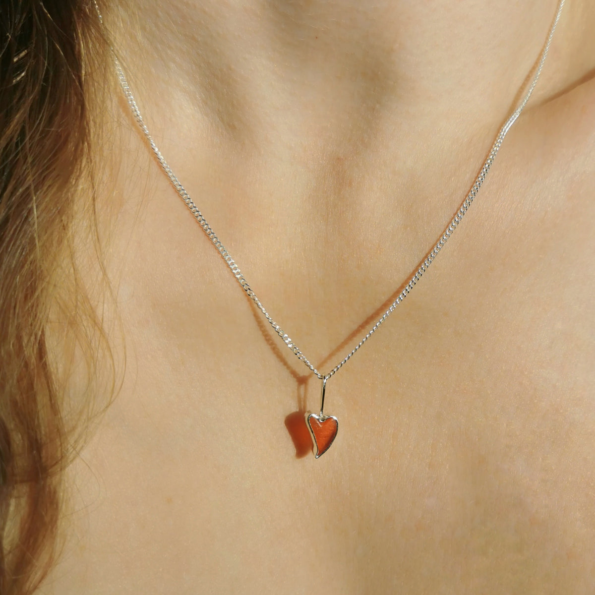 Tiny Scottish orange sea glass heart  & sterling silver pendant.